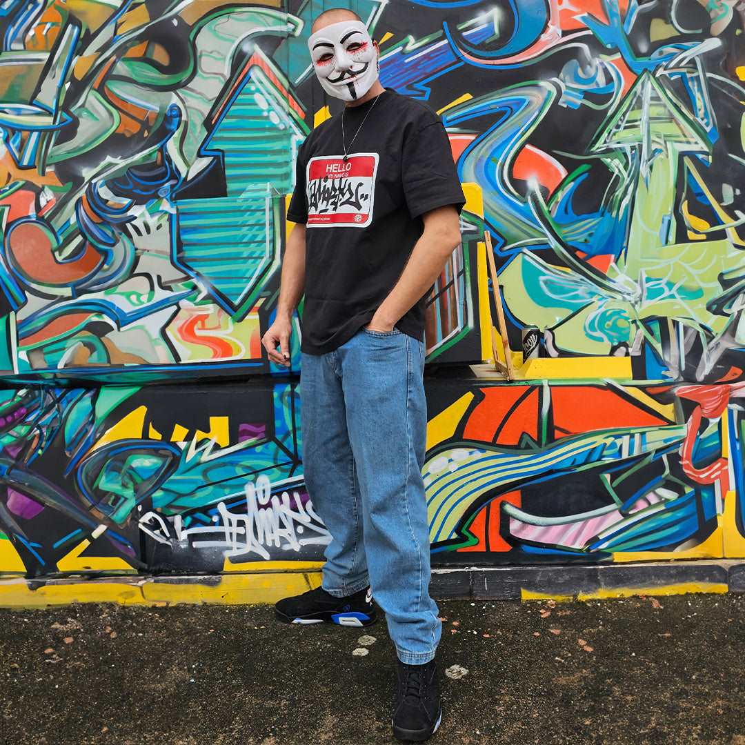 Black-Dmark wearing the Hello My Name Is Sticker Graffiti Tee from B.Different Clothing, graffiti-inspired streetwear t-shirt