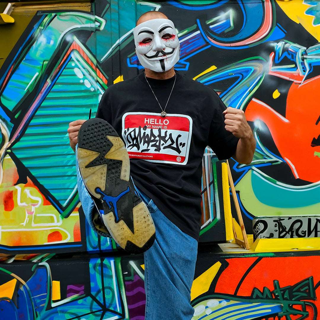 Black-Dmark wearing the Hello My Name Is Sticker Graffiti Tee from B.Different Clothing, graffiti-inspired streetwear t-shirt