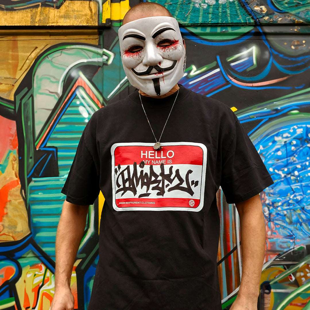 Black-Dmark wearing the Hello My Name Is Sticker Graffiti Tee from B.Different Clothing, graffiti-inspired streetwear t-shirt
