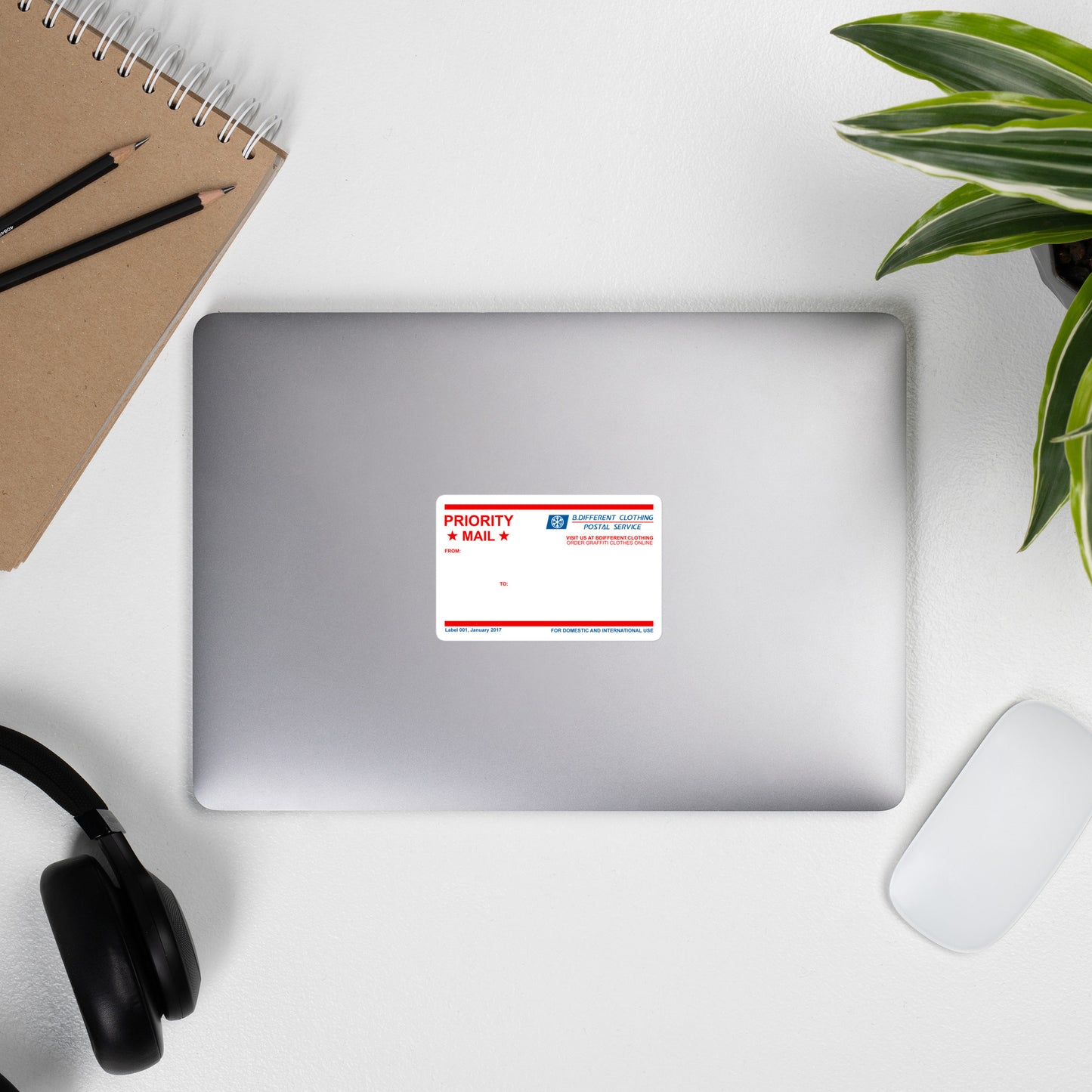 laptop with Priority Mail Graffiti Sticker from B.Different Clothing, front view, graffiti-inspired streetwear
